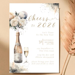 May include: New Year's Eve invitation with watercolor champagne bottle, champagne glass, and floral bouquet. The invitation reads "Cheers to 2026" with event details. The design features gold and neutral tones.