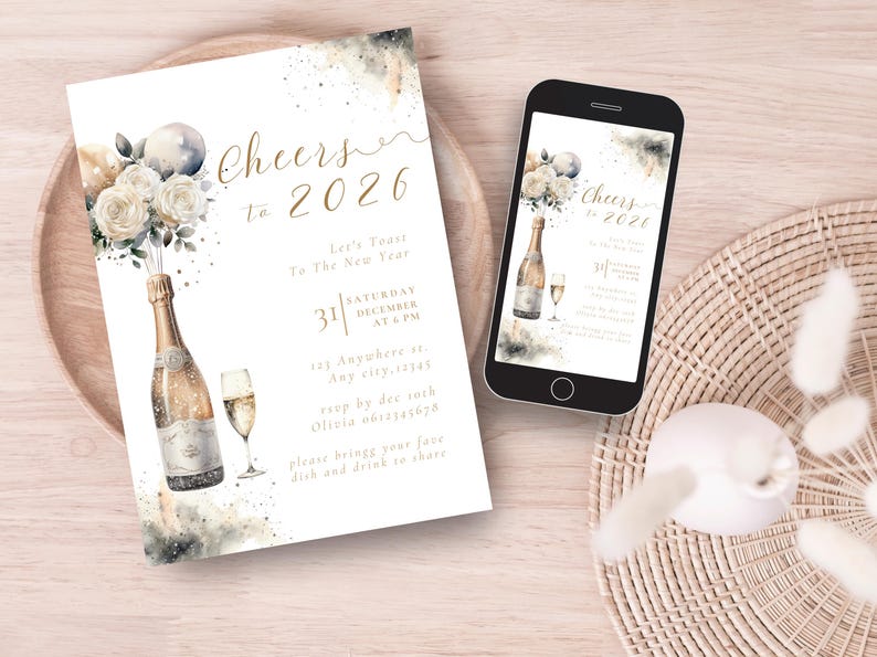 May include: New Year's Eve invitation with a champagne bottle, champagne glass, and floral arrangement. The invitation reads "Cheers to 2026" with event details. A smartphone displays the same design. The design is on a wooden plate.