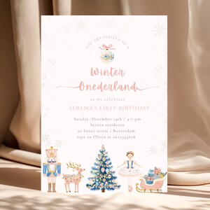 May include: A pale pink invitation for a winter-themed first birthday party. The invitation features the text "Winter Onederland" and includes illustrations of a nutcracker, reindeer, Christmas tree, ballerina, and sleigh.