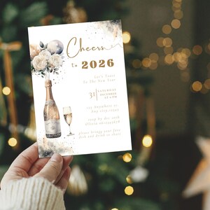 May include: A New Year's invitation card with a champagne bottle and glass illustration. The card reads "Cheers to 2026" with event details. The design features watercolor elements and a festive theme, perfect for a holiday celebration.