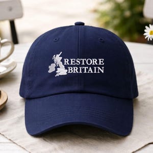 May include: A white ceramic mug with a black handle and the text "But First, Coffee" in a black, bold font. The mug is on a wooden surface.