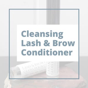 May include: A white bottle and tube of Lash & Brow Conditioner are displayed on a stone surface. The text "Cleansing Lash & Brow Conditioner" is centered in a white box. Additional text on the products includes "Lash & Brow Gloss Pour C" and "Lash & Gloss F".