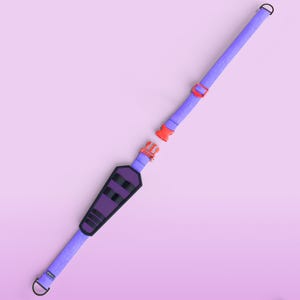 May include: A lilac dog collar with a black and purple padded section and a red buckle. The collar is unfastened, showing the two separate pieces. The background is a gradient of pink and purple.