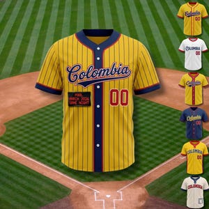 May include: Yellow baseball jersey with navy and red detailing. The jersey has vertical stripes, the word "Colombia" in script, and the number "00". A patch reads "POOL MARCH 2026 GAME NIGHT". Other jerseys in different colours are also displayed.
