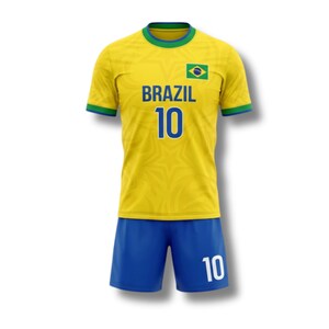 May include: A yellow soccer jersey and blue shorts set. The jersey has the word "BRAZIL" in blue, the number "10", and a Brazilian flag patch. The shorts also feature the number "10". The jersey has green and blue trim.