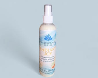 Ambientador en aerosol Radiant Joy: aroma a naranja dulce, vainilla y albahaca