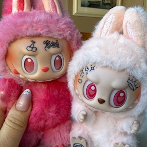 Includes authentic PopMart Labubu plush, customized with real tattoos