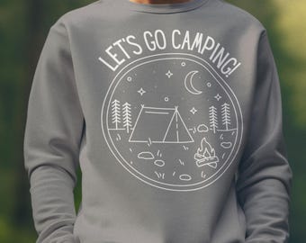 May include: Gray sweatshirt with a white graphic that says "LET'S GO CAMPING!" The graphic features a tent, trees, a campfire, a crescent moon, and stars. The sweatshirt is a crew neck.