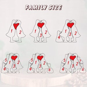 May include: White wooden duck family figurines with red heart accents. The text "FAMILY SIZE" is at the top. The figurines are numbered to indicate family size, ranging from two to six ducks.