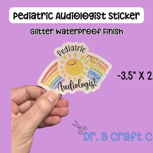 May include: A glitter waterproof sticker for a pediatric audiologist. The sticker features a smiling sun, a rainbow, and the words "Pediatric Audiologist." The sticker measures approximately 3.5 inches by 2.5 inches.
