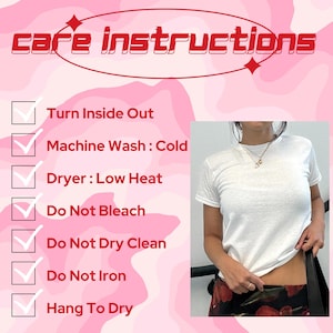 May include: A white crew neck t-shirt with care instructions in a pink and red design. The instructions include turning the garment inside out, machine washing cold, low heat drying, and avoiding bleach, dry cleaning, and ironing.
