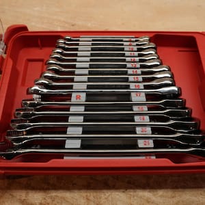 May include: A set of chrome wrenches, ranging from 8 to 21, neatly arranged in a red plastic case. The wrenches are labeled with their sizes in inches. The case has a clear lid and a handle for easy transport. The tools are for mechanical work.