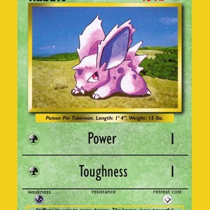 May include: A green trading card featuring a purple creature illustration, labelled Token Creature Rabbit with 40 HP. The card text includes Poison Pin Pokémon, Length: 1' 4", Weight: 15 lbs., Power 1, Toughness 1, and a description about stiffening ears.