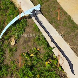 May include: A large scythe with a curved, silver blade and a long, black handle. The handle has a textured design. The image also includes several decorative swords. The text "ENABLER'S CRAFTER" is visible.