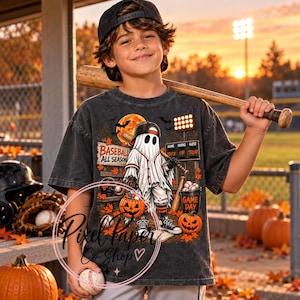 May include: A charcoal gray short-sleeve t-shirt featuring a graphic of a ghost wearing a baseball cap and uniform, holding a bat. The design includes a scoreboard, pumpkins, autumn leaves, and the text BASEBALL ALL SEASON and GAME DAY.