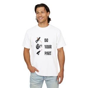 May include: A white short-sleeved t-shirt featuring a graphic design with a hand saw, a person using a spray paint can, and a ray gun, accompanied by the black text DO YOUR PART arranged vertically in a distressed, bold, sans-serif font.