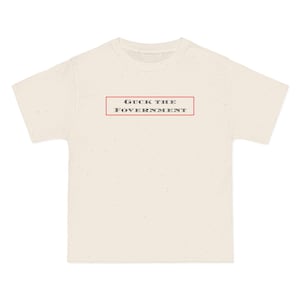 May include: Cream-colored t-shirt with a speckled pattern. The shirt features the text "GUCK THE FOVERNMENT" in a red rectangular box. The shirt has a crew neck and short sleeves.