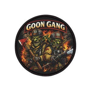 Può includere: Toppa rotonda con la scritta "GOON GANG" sopra due pompieri goblin verdi in tenuta gialla, uno con un'ascia e l'altro con un tubo. Lo sfondo è fatto di fiamme.