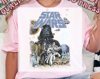 May include: A light pink DTF transfer featuring a Star Wars design. The graphic includes Darth Vader, other characters, and the Star Wars logo in blue. The words "HIGH QUALITY" and "READY TO PRESS" are printed at the top, and "DTF TRANSFERS" at the bottom.