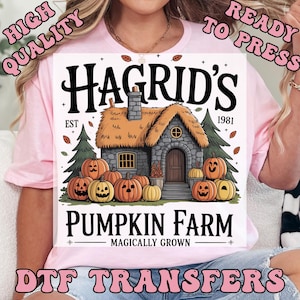 May include: A light pink t-shirt featuring a graphic design for DTF transfers. The design includes the text "Hagrid's Pumpkin Farm" with a cottage and pumpkins. The words "High Quality" and "Ready to Press" are also visible.