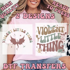May include: Pink t-shirt with two DTF transfer designs. One design features a dragon and the text "Violent Little Thing". The other design has the same text and a dragon, book, and stars. The text "High Quality Ready to Press" is also visible.