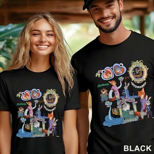 May include: Black t-shirts featuring a colorful graphic of characters from the animated movie Zootopia. The design includes various animal characters in a framed design with the word "Zootopia" below. The word "BLACK" is printed at the bottom.