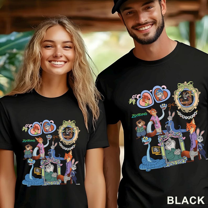 May include: Black t-shirts featuring a colorful graphic of characters from the animated movie Zootopia. The design includes various animal characters in a framed design with the word "Zootopia" below. The word "BLACK" is printed at the bottom.