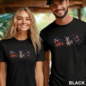 May include: Black t-shirts featuring a dachshund dog design with patriotic bows and stars. The shirts are worn by two people. The word "BLACK" is printed in white at the bottom right corner.