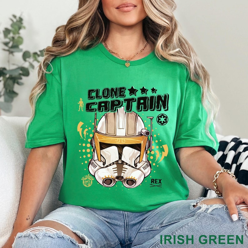 May include: A green t-shirt with the text "CLONE CAPTAIN" and a graphic of a white and gold helmet. The shirt also has the text "REX" and "IRISH GREEN".