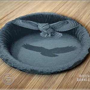 May include: A round, dark gray decorative tray with a laser-etched owl design. The owl is depicted with outstretched wings, and a shadow of the owl is below. The tray has a textured edge and the words "DIGITAL DOWNLOAD" are visible.