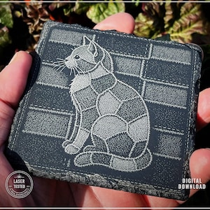 May include: A dark grey slate coaster featuring a laser-etched design of a cat in a patchwork style. The cat is sitting, with its tail curled. The coaster has a rough, natural edge. The words "Laser Tested" and "Digital Download" are also visible.