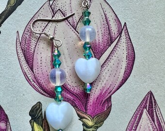 Green crystals and white heart earrings.