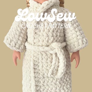 May include: A doll wearing a cream-colored, chunky crochet robe with long sleeves and a matching tie belt. The text "LowSew CROCHET PATTERN" is overlaid in white across the upper portion of the robe, indicating a design guide for this garment.