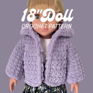 May include: A doll with blonde hair wearing a lavender hooded crochet jacket over a white shirt and a dark blue skirt with a floral pattern. The text 18" Doll CROCHET PATTERN is displayed in white over the doll's head and shoulders.