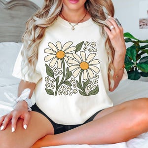 a woman sitting on a bed with her legs crossed