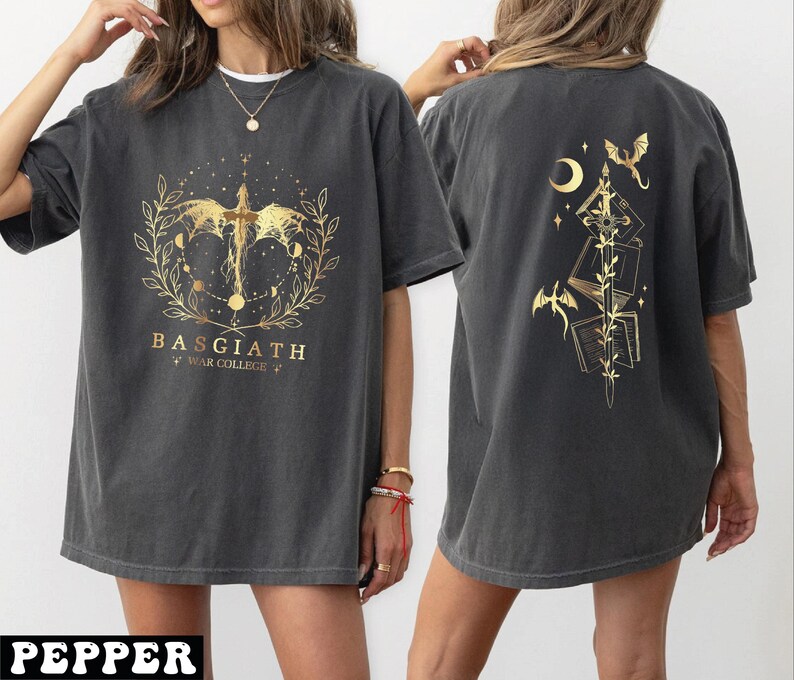 A woman wearing a grey t-shirt with a gold design on the front and back.