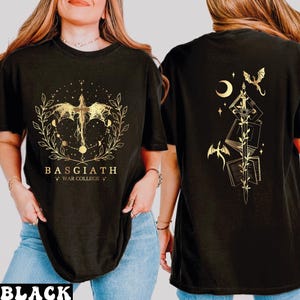A woman wearing a black t-shirt with a gold design on the front and back.