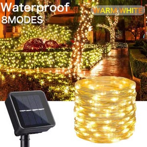 May include: A solar-powered string light set with warm white LEDs. The image shows a roll of lights, a solar panel, and a garden scene illuminated by the lights. Text on the image reads "Waterproof 8 MODES" and "WARM WHITE".