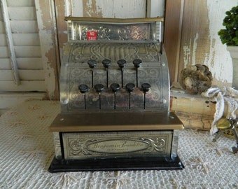 Gold With Black Print and Designs With Red Bottom Vintage Toy Cash Register Black and Red Plastic Handle Push Buttons to Raise Numbers.