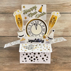 Tarjeta de Año Nuevo desplegable en caja 3D, color negro, blanco y dorado, lunares, copas de champán, reloj de cuenta regresiva, se pliega para enviar por correo, envío gratuito a EE. UU.