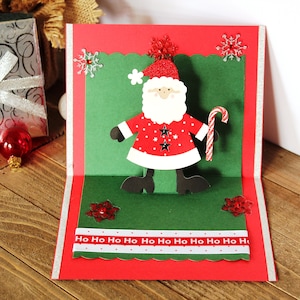 Biglietto di Natale pop-up l Ho Ho Ho l Babbo Natale l Bastoncino di zucchero l Fiocchi di neve l Pezzo unico l Interno vuoto