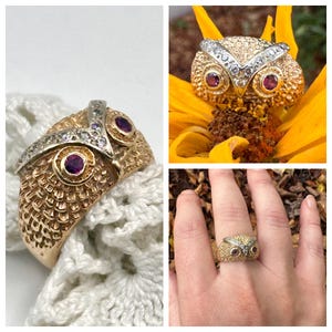 May include: A gold-toned owl ring with ruby eyes and a silver-toned band. The owl's feathers are textured, and the ring is shown in multiple views, including on a finger and in a flower. The ring is a unique piece of jewelry.