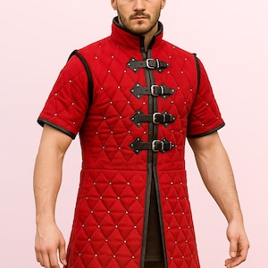 Medieval gambeson, an arming coat or padded jacket quilted, padded garment armour.Thick Padded Half Sleeves Gambeson Coat Aketon Armor