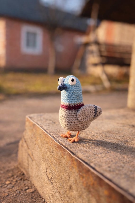 A handmade crochet pigeon with full city-bird energy — the kind of absurdist desk companion that sparks instant conversation.