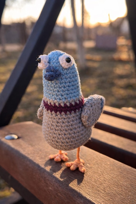 A handmade crochet pigeon with chaotic city-bird energy — amigurumi that actually has a distinct, weird personality.