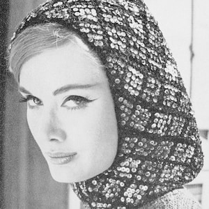 Op de afbeelding: Een zwarte, met pailletten bezette capuchon met een close-up van het gezicht van een vrouw die de capuchon draagt.