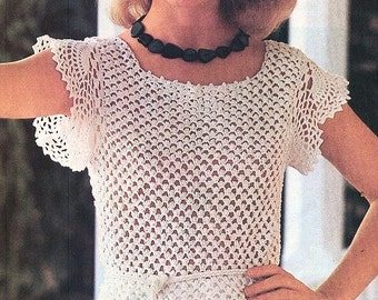May include: White crochet top with a delicate openwork pattern and a matching crocheted belt. The top has short sleeves and a round neckline.