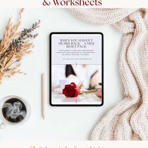 May include: A digital tablet displays text: "When You Haven't Heard Back - A Mini Reset Pack." A red rose rests near the tablet. The image includes a cup of coffee, a pencil, and a beige knitted blanket. Text at the bottom reads: "Calm spirals of overthinking" and "Build confidence in early dating."