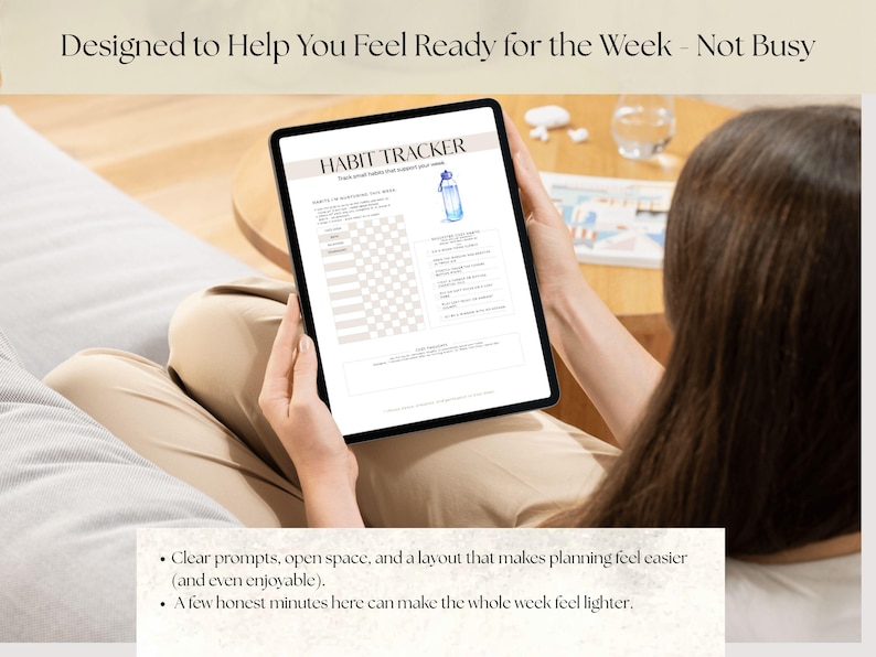 May include: A digital tablet displaying a habit tracker with a light beige background. The text "HABIT TRACKER" is at the top. The image includes a watercolor illustration of a water bottle. The text "Designed to Help You Feel Ready for the Week - Not Busy" is at the top.