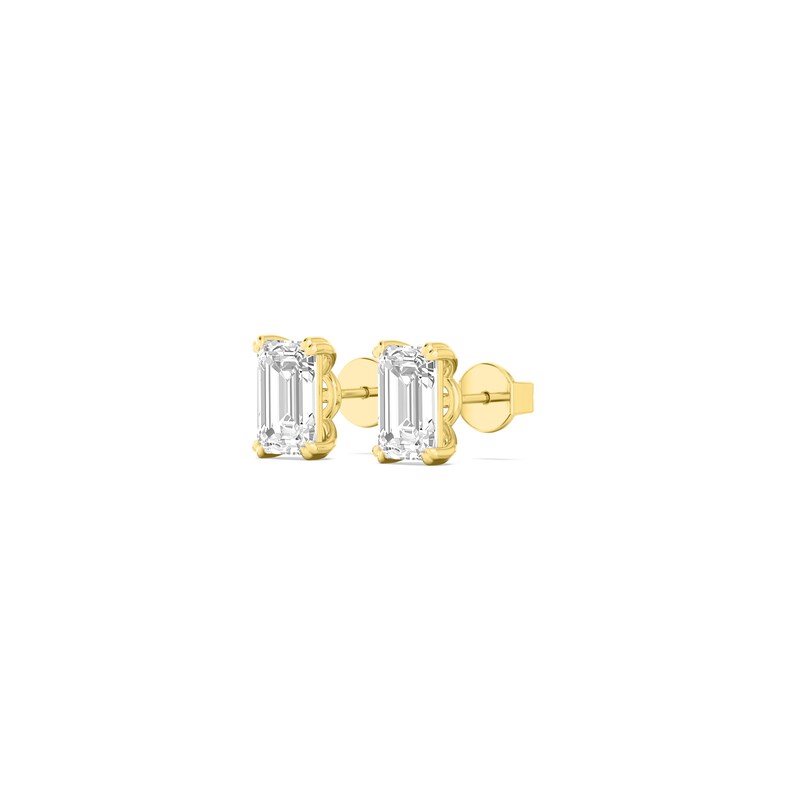 May include: A pair of gold stud earrings with emerald-cut, clear gemstones. The earrings are set in a gold bezel setting and have a post and butterfly backing. The earrings are displayed on a white background.